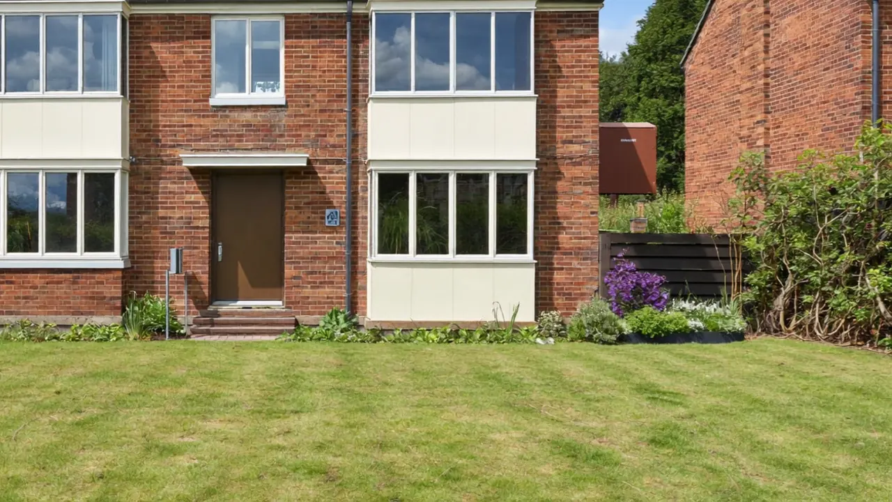 Close-up of a fitted composite front door and adjacent double-glazed window