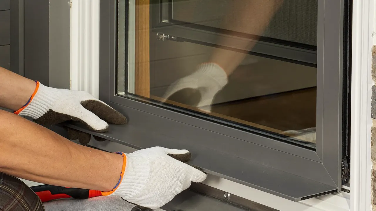 A two-person team fitting a bay window at a UK home