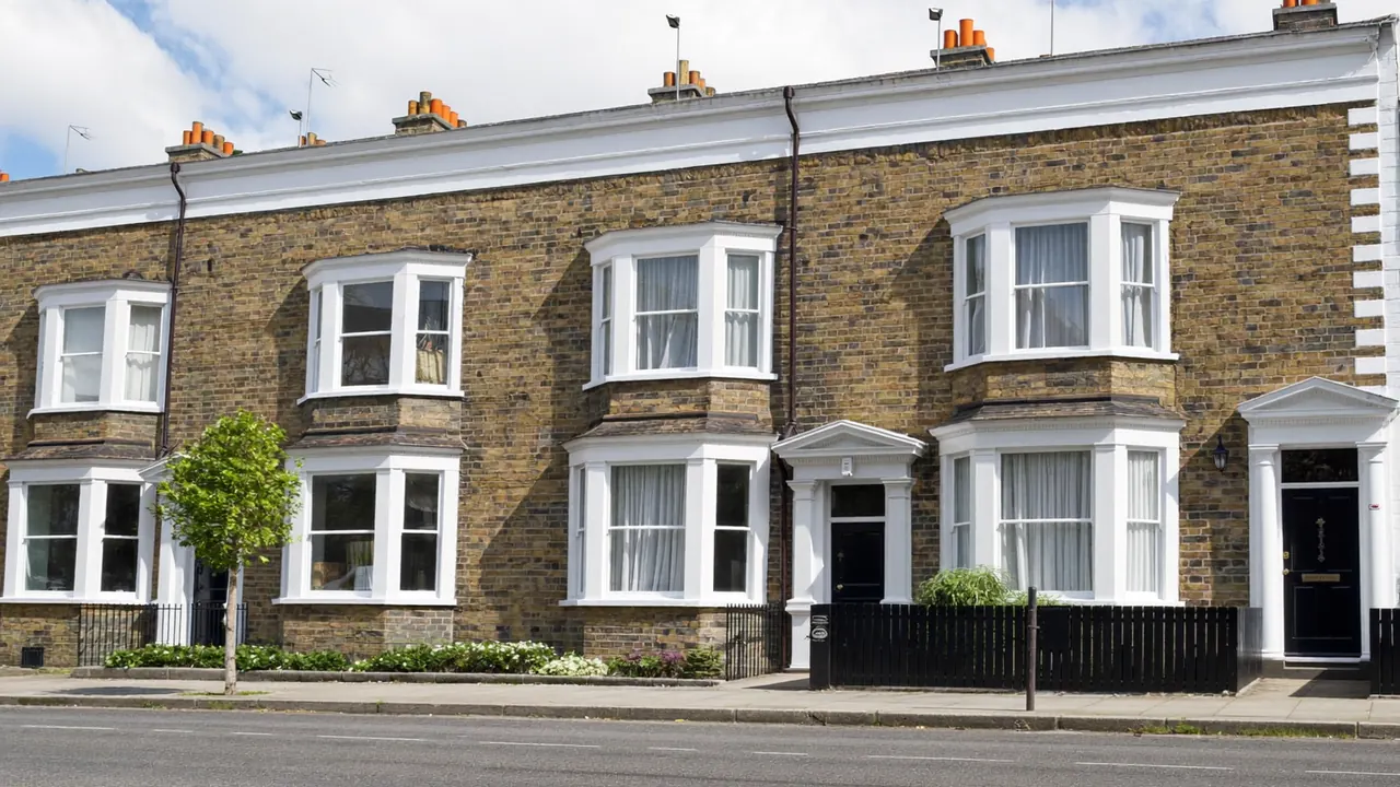 A row of UK terraced houses fitted with new white double-glazed windows