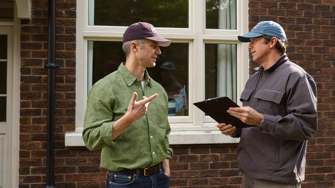 A window installer meeting a homeowner on the doorstep for a consultation
